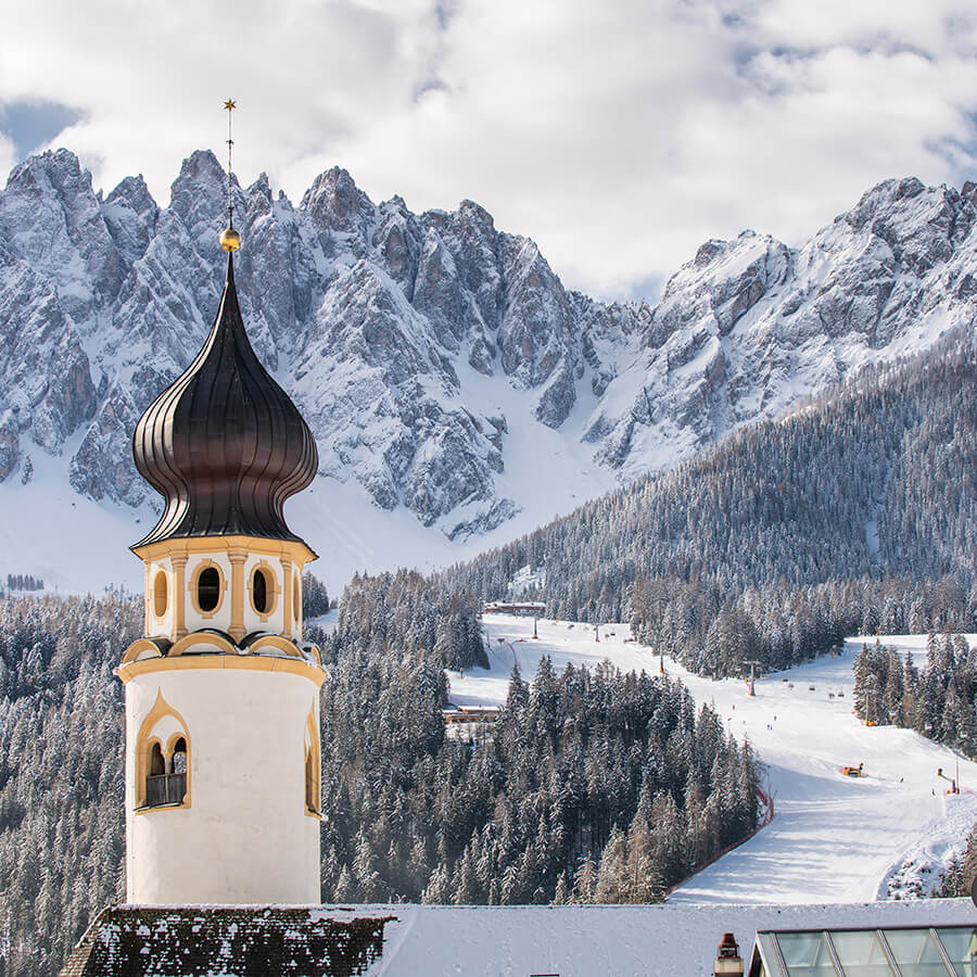 View of the San Michele Parish church and the mountain Rocca dei Baranci
